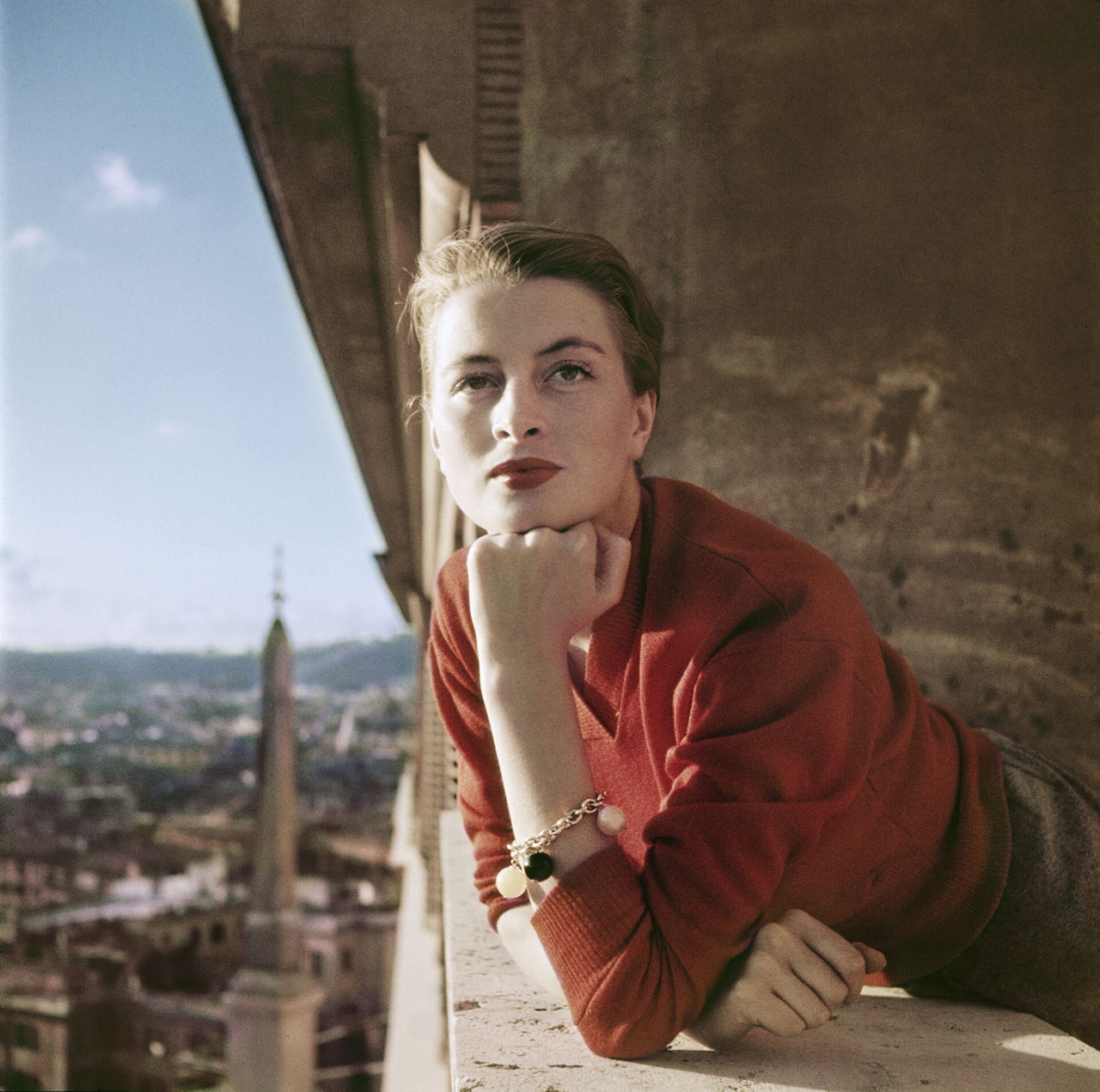 Robert Capa, [Capucine, French model and actress, on a balcony, Rome], August 1951. Collection International Center of Photography, New York, Credit ICP/Magnum Photos